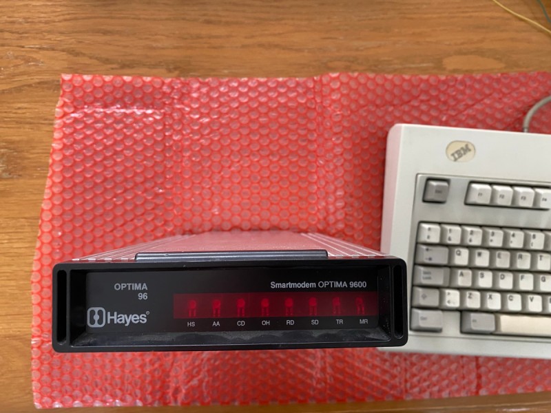 Picture of a Hayes Optima 9600 modem and an IBM keyboard